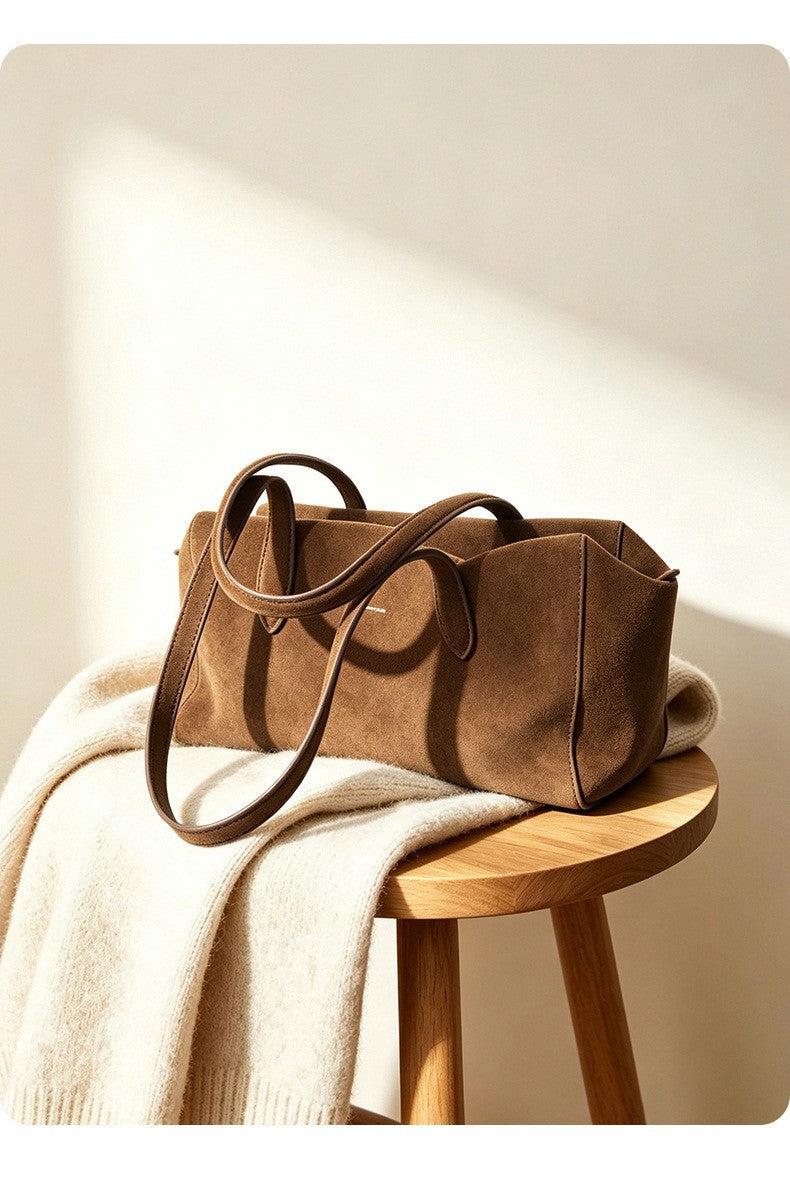 Caramel suede shoulder tote styled on a stool