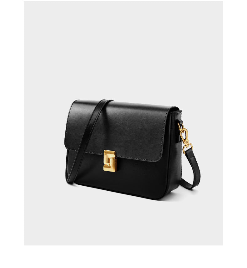 Black cowhide leather crossbody bag angled view showing turn-lock detail