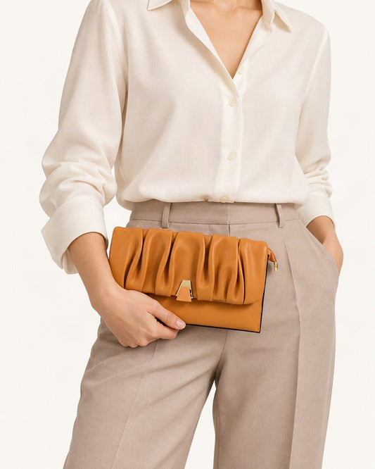 Cowhide Leather Pleated Clutch Bag held in hand by a model