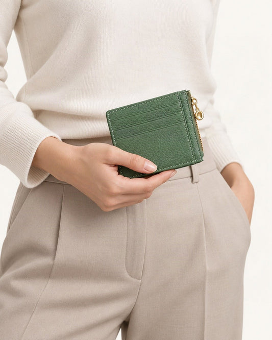 Top-Grain Cowhide Slim Card Holder with Zip Coin Pocket held in hand by a model