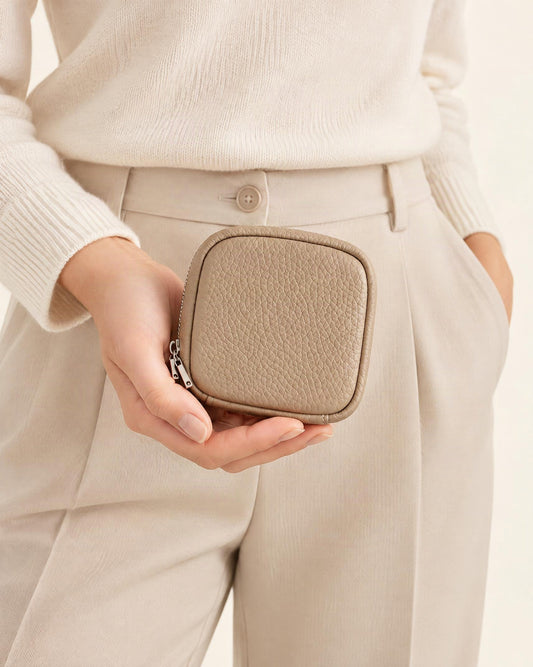 Pebbled Leather Mini Cosmetic Pouch held in hand by a model