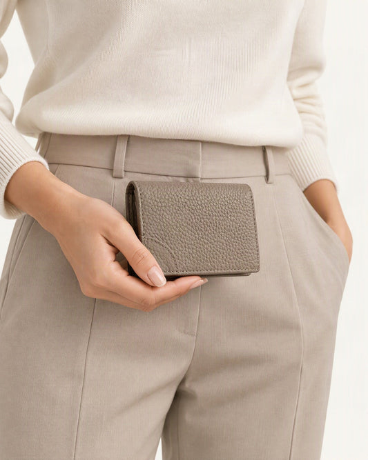 Cowhide Leather Mini Bifold Card Holder Wallet held in hand by a model