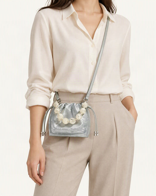 Cowhide Mini Bucket Bag Crossbody Drawstring Bead Handle worn crossbody