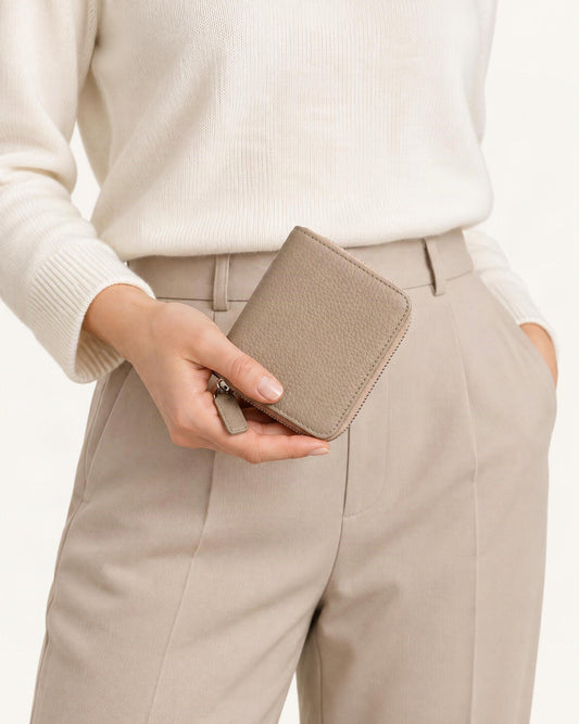 Cowhide Leather Compact Bi-Fold Wallet held in hand by a model