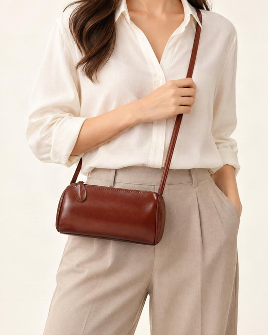 Top-Grain Cowhide Mini Barrel Crossbody Bag worn crossbody