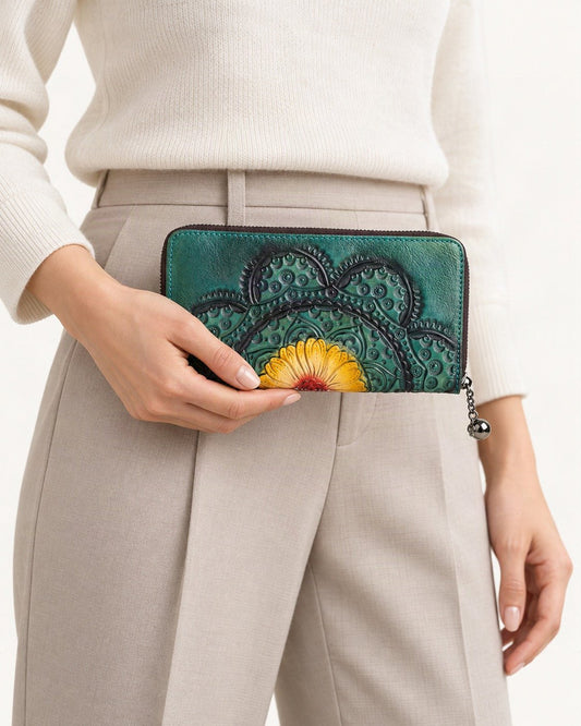 Top-Grain Cowhide Zip-Around Wallet with Floral Embossing held in hand by a model