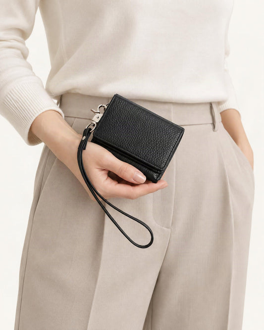 Cowhide Leather Tri-Fold RFID-Blocking Wallet held in hand by a model