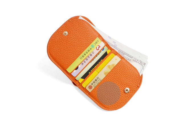 Open orange wallet displaying card slots filled with sample cards and banknotes