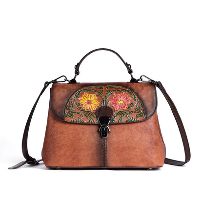 Front view of the brown embossed floral crossbody bag