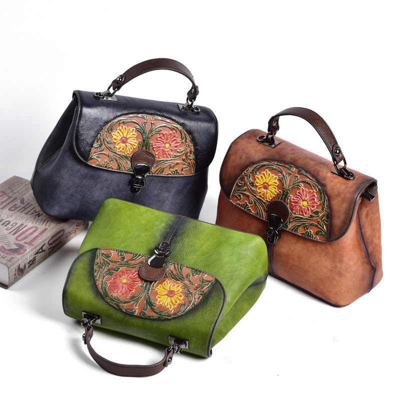 Green, brown, and black floral leather bags shown together