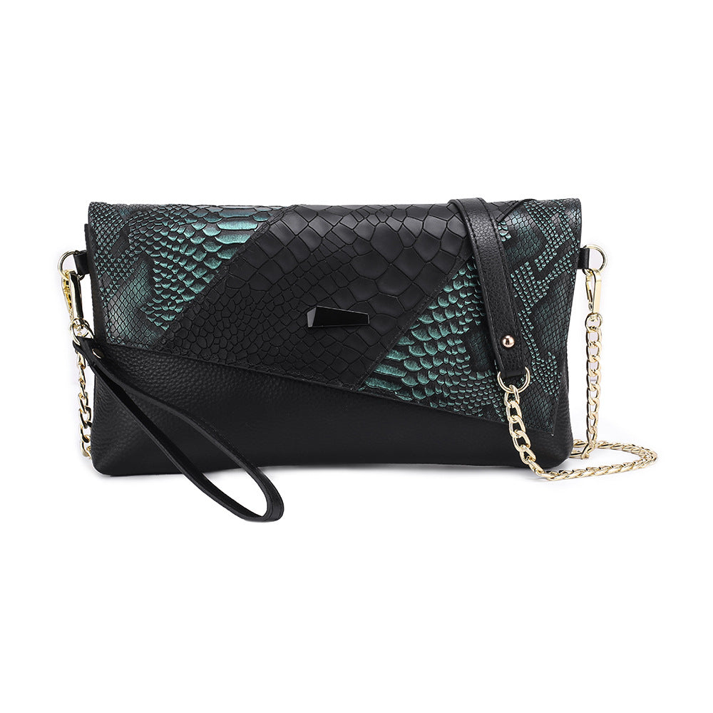 Black clutch with teal green snake-pattern panels