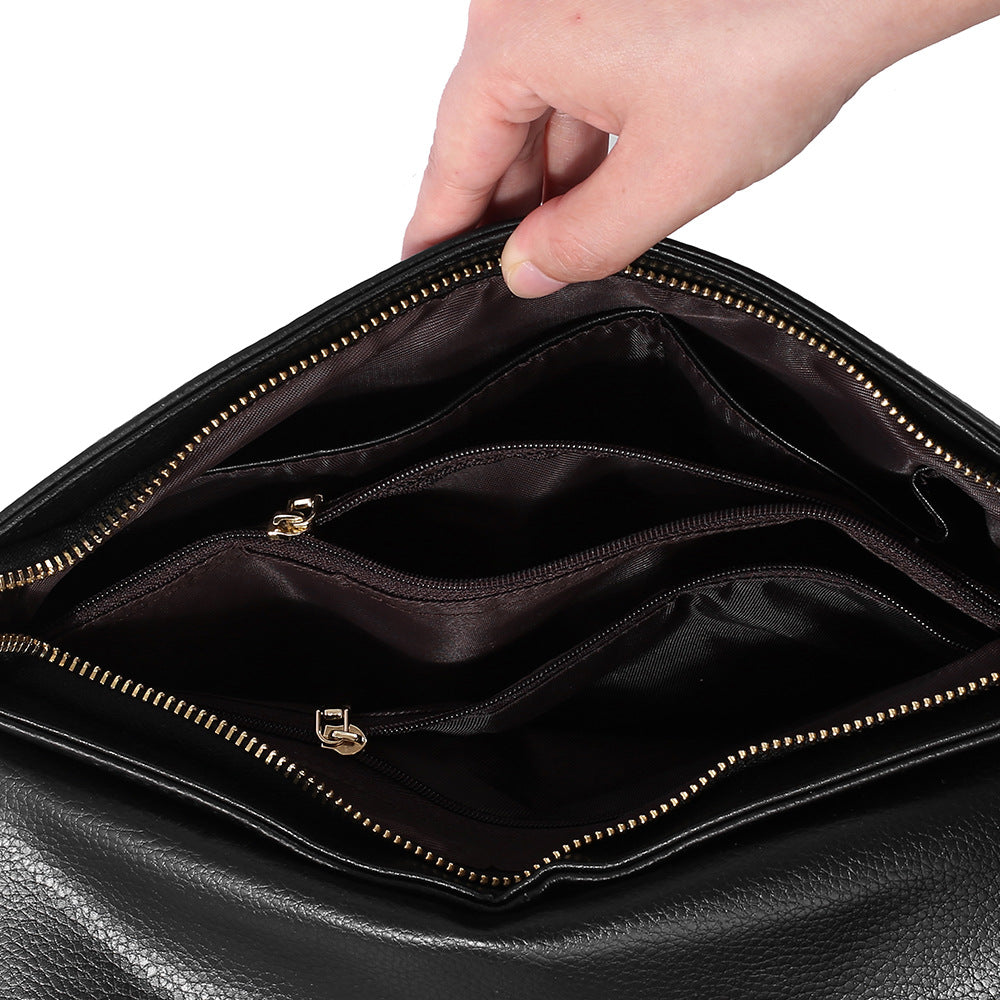 Open clutch showing divided interior and zip pockets