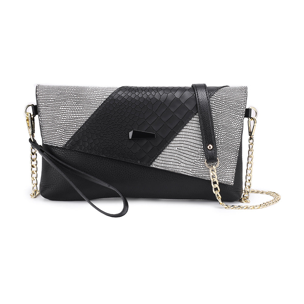 Black flap clutch with reptile-textured panel and chain strap