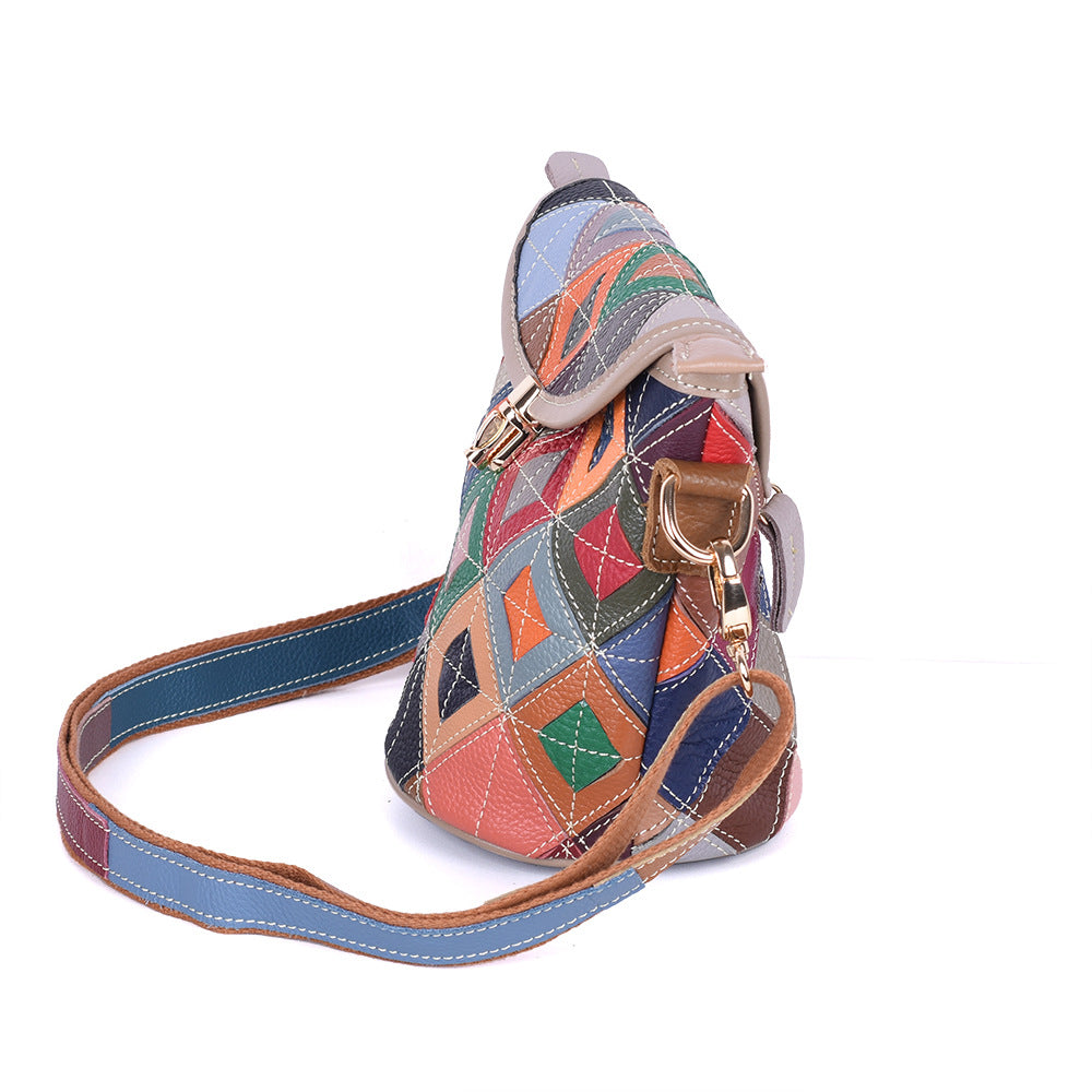 Side profile of geometric cowhide bag and attached strap
