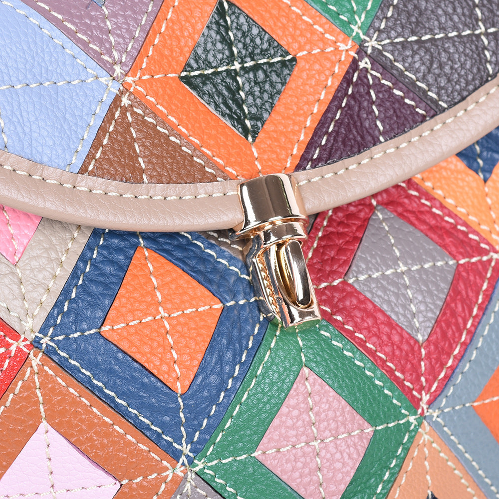 Detail of the front flap clasp against geometric cowhide panels