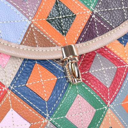 Detail of the front flap clasp against geometric cowhide panels