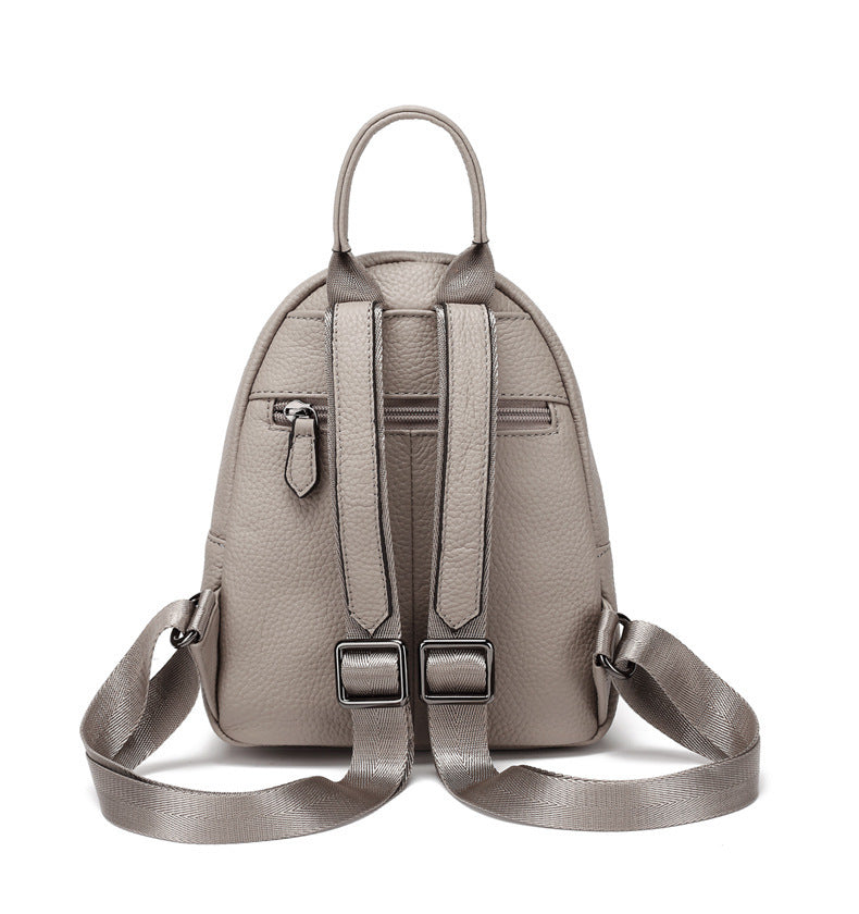 Back view showing the backpack straps and rear zip pocket