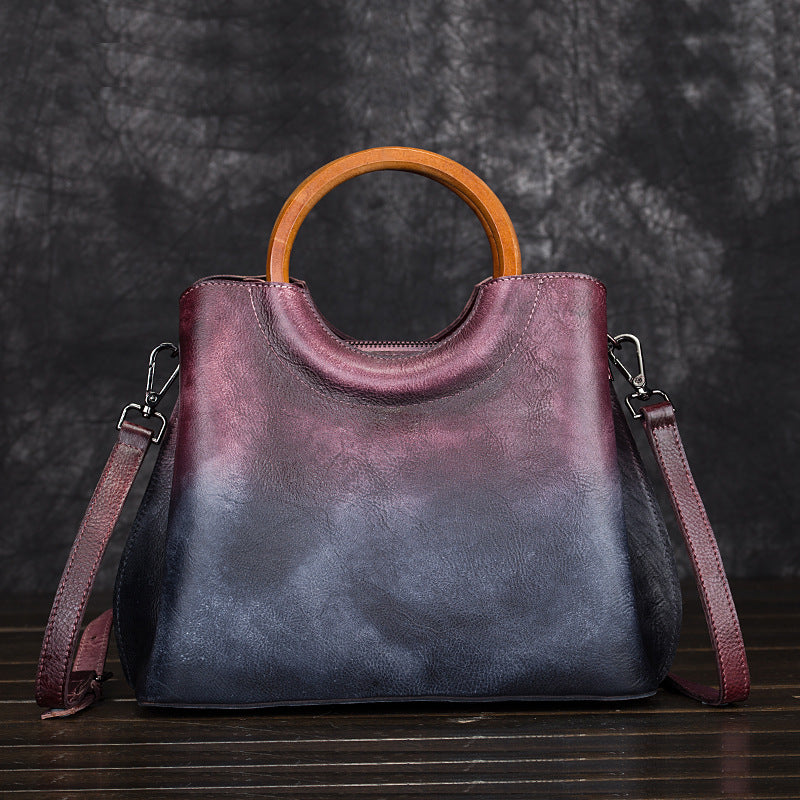 Burgundy and dark blue cowhide handbag with detachable-looking shoulder strap