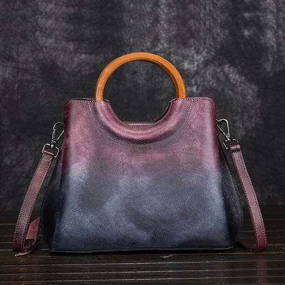 Burgundy and dark blue cowhide handbag with detachable-looking shoulder strap