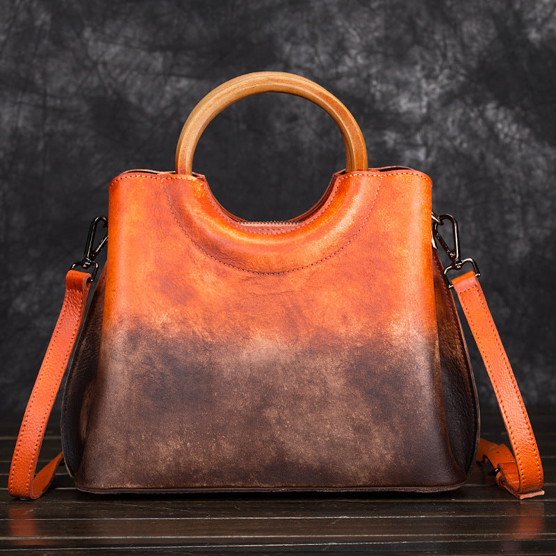 Orange and brown vintage leather bag with rounded handle