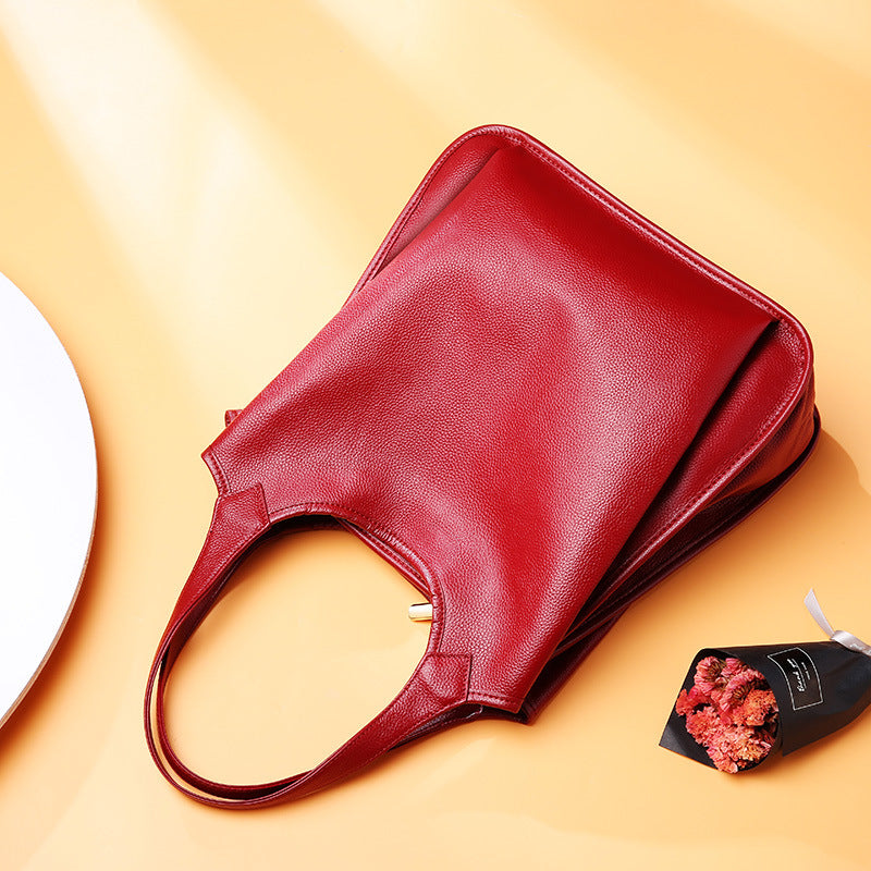 Top-down view of wine red leather tote showing handle detail