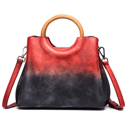 Red and black colorblock top-handle crossbody bag on a white background