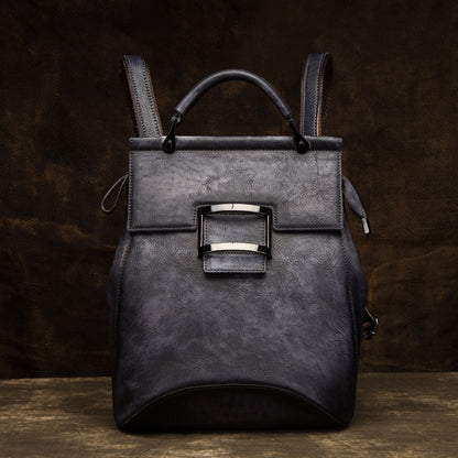 Black vintage cowhide backpack with flap front and top handle