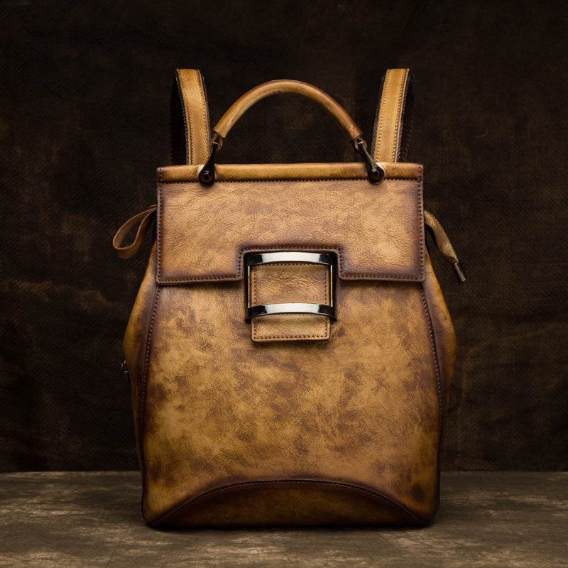 Yellow-brown leather backpack showing its textured finish and front detail