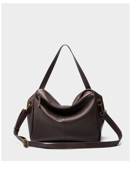 Back view of coffee brown tote showing zip top closure and detachable adjustable strap