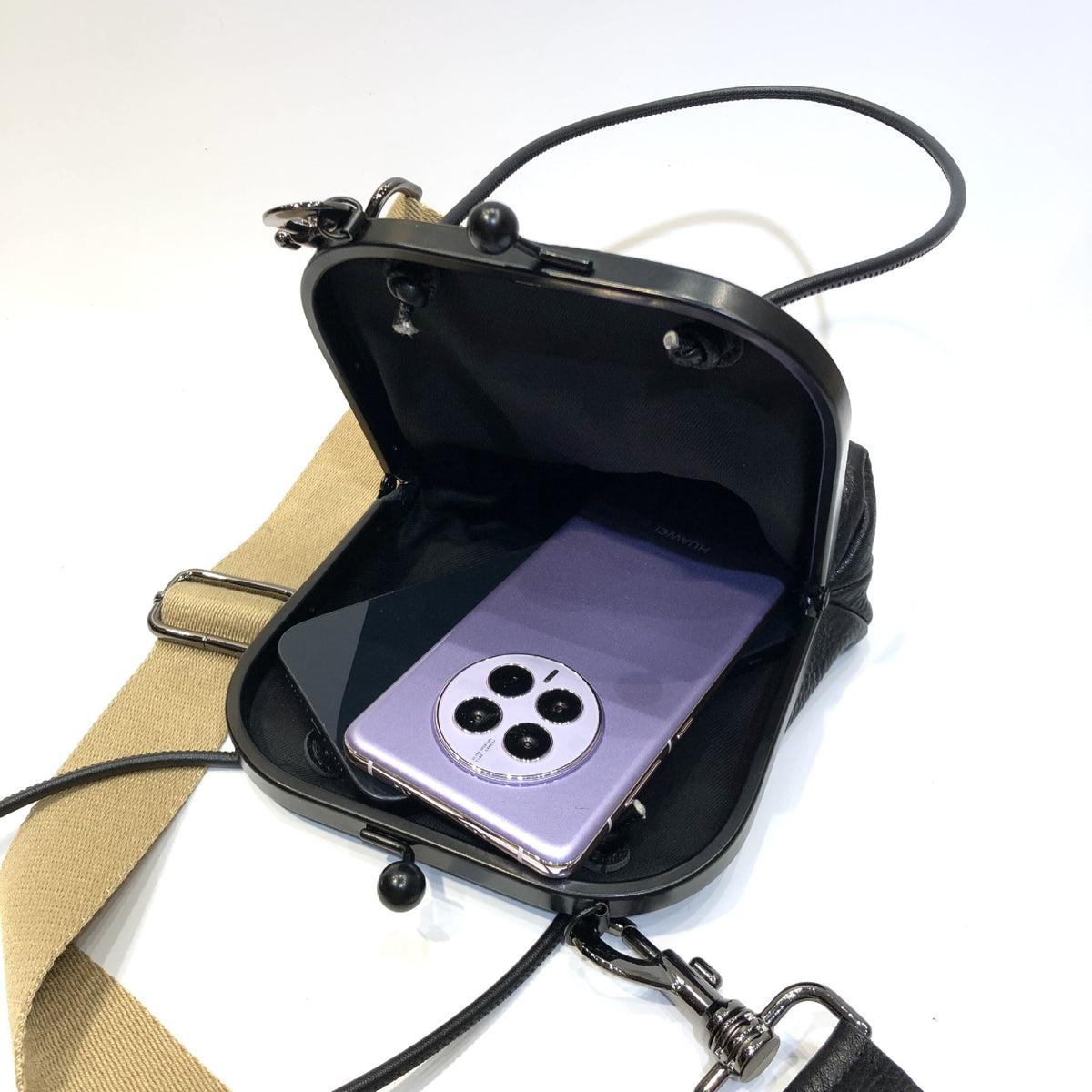 Black leather bag viewed from the back with strap