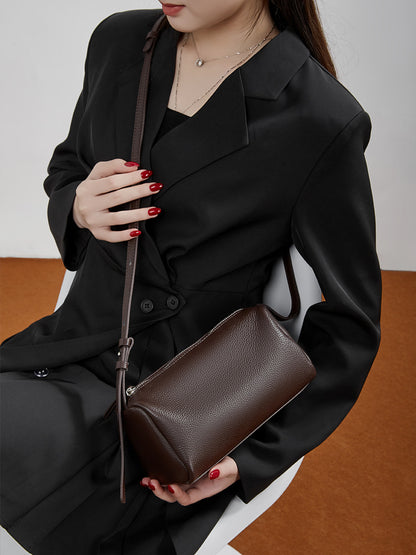 Model holding the coffee barrel bag showing the adjustable shoulder strap