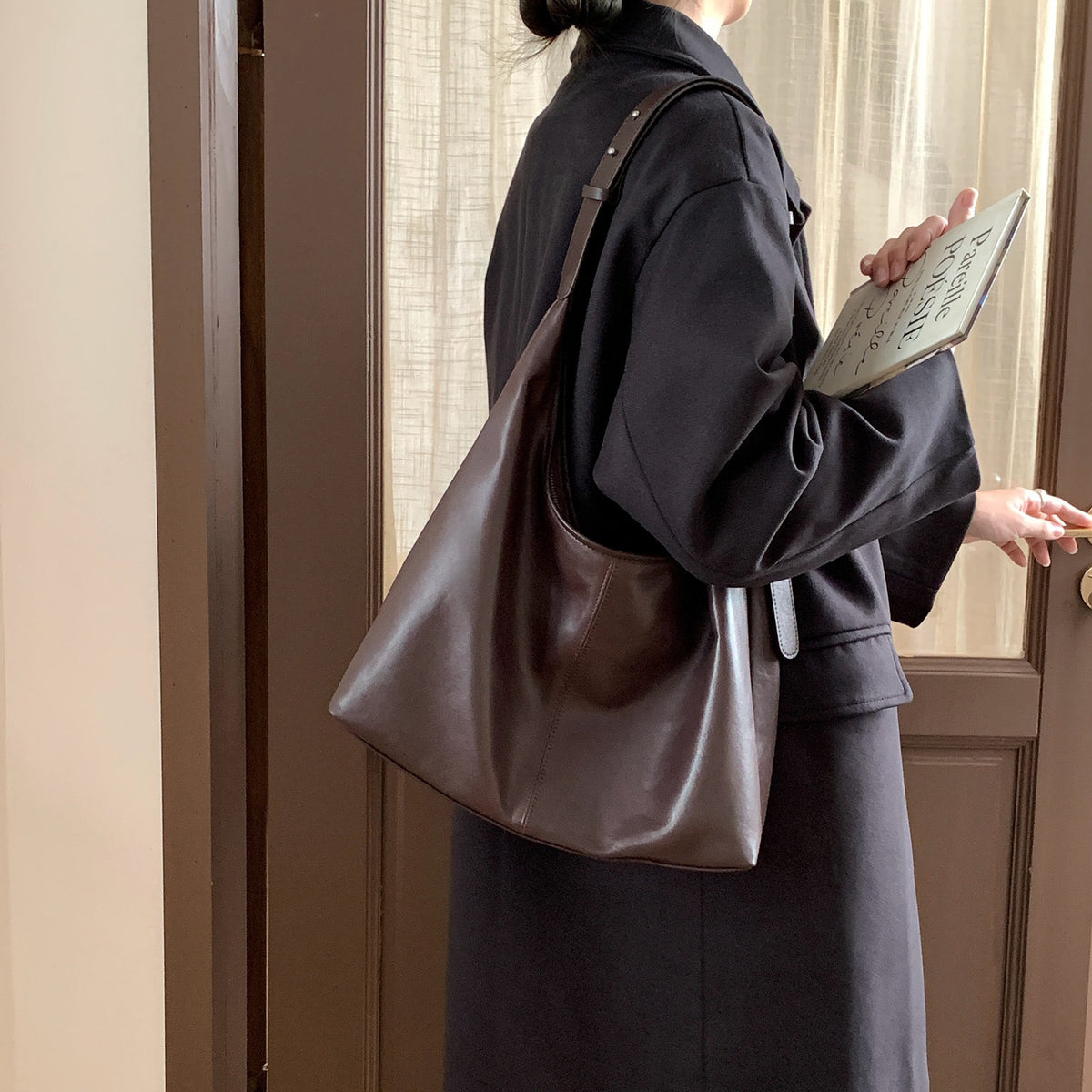 Ebony brown shoulder tote carried on the shoulder