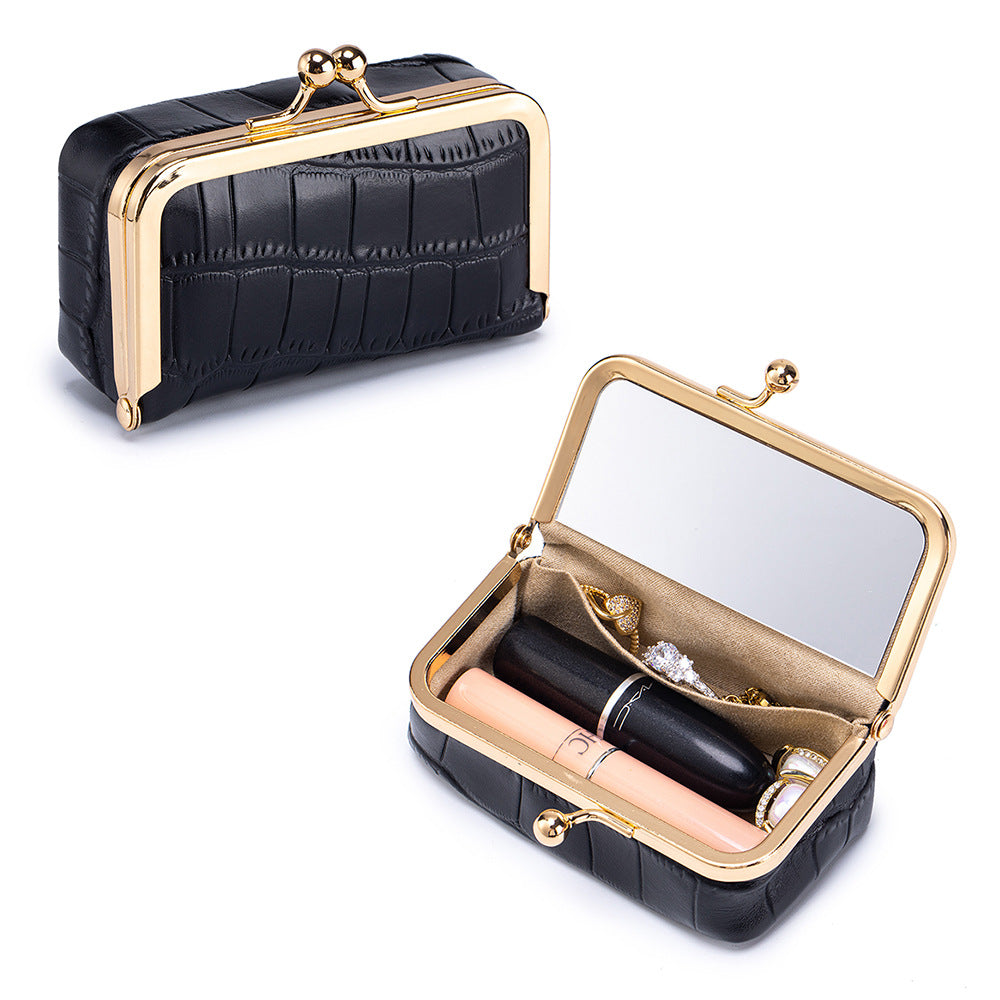 Black crocodile-embossed pouch with gold-colored frame