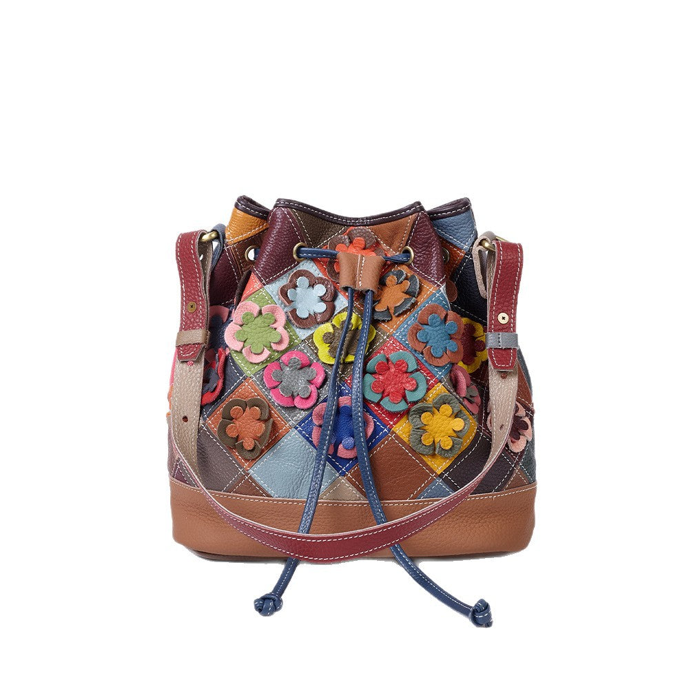 Front view of leather patchwork bag with drawstring closure