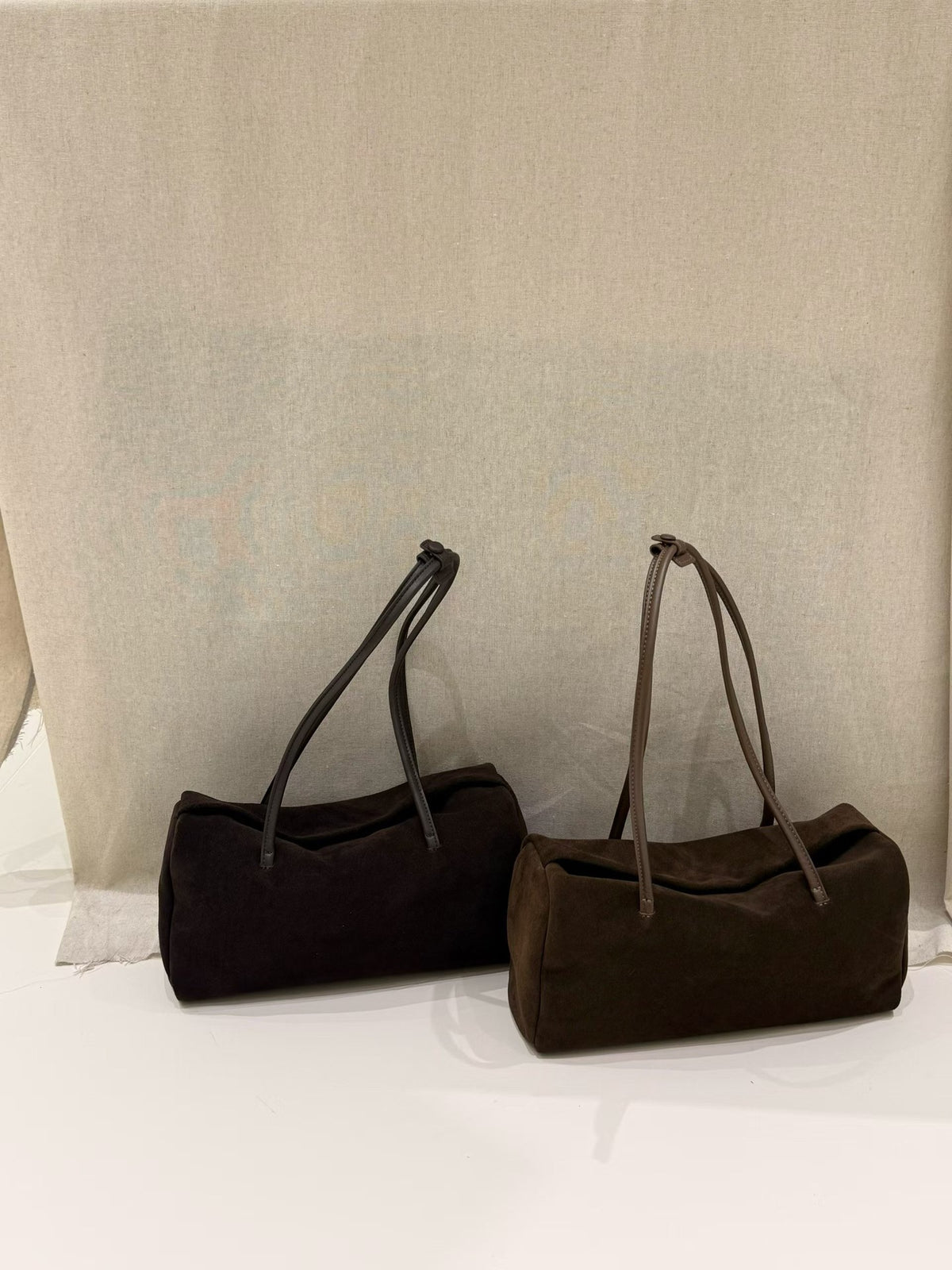 Brown Boston tote presented upright with long shoulder handles