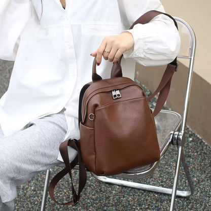 Coffee brown backpack held by its top handle