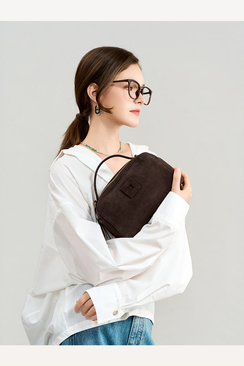 Lifestyle view of the bag held against a white outfit