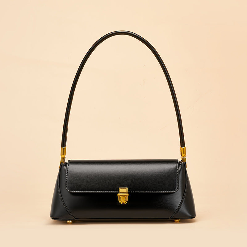 Black smooth cowhide baguette bag front view with brass clasp closure