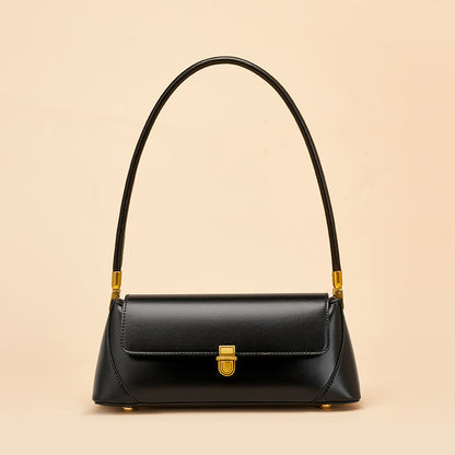 Black smooth cowhide baguette bag front view with brass clasp closure
