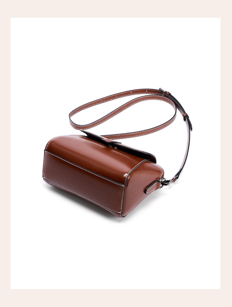 Angled top view of brown leather crossbody bag showing strap slider