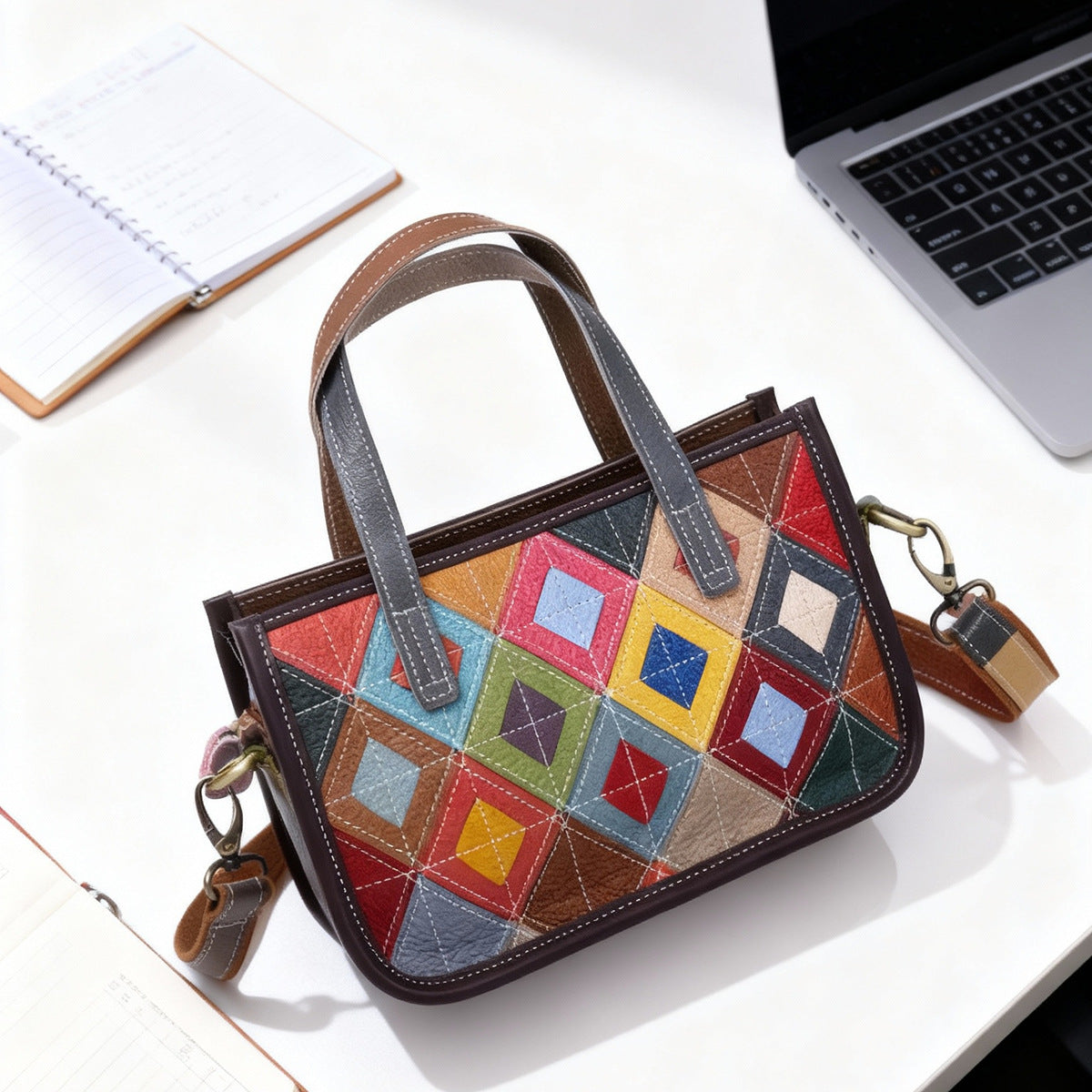 Angled view of colorful diamond patchwork leather bag with shoulder strap