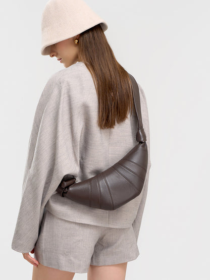 Back view of model with coffee crescent bag worn as crossbody