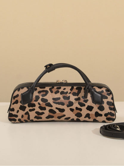 Leopard-print cowhide handbag displayed with top handles and shoulder strap