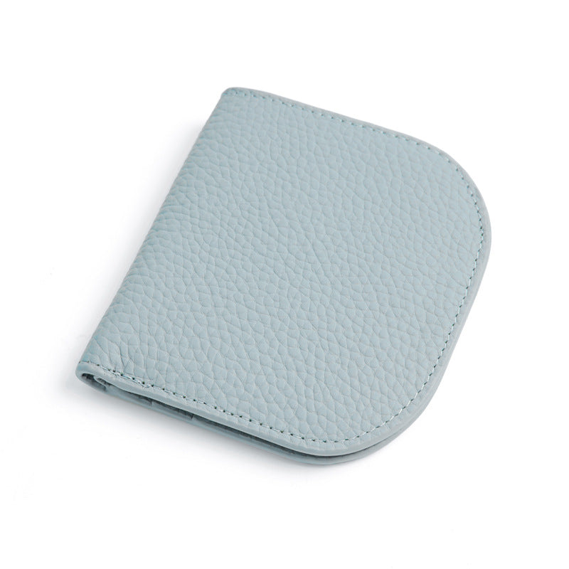 Light blue pebbled cowhide leather bifold wallet closed on white background
