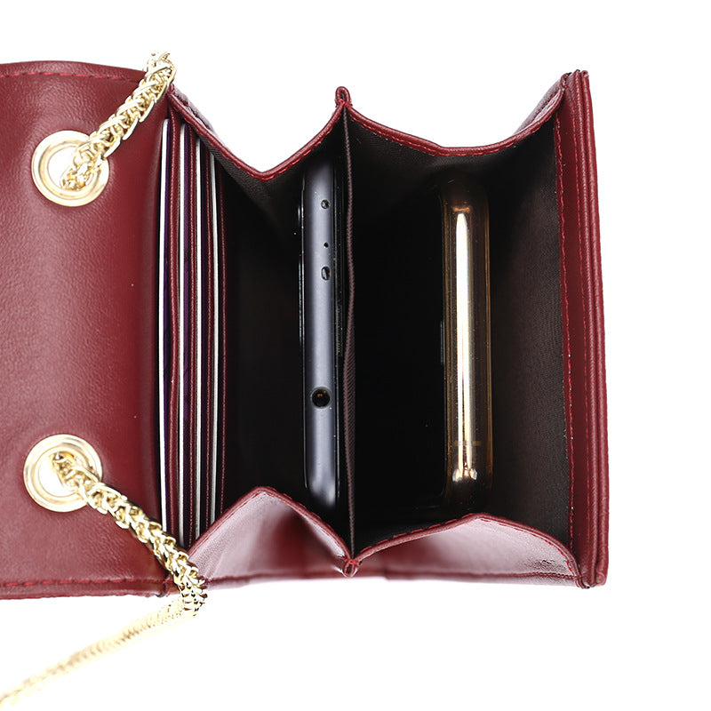 Interior view of cowhide phone bag showing two compartments and four card slots holding a phone and cards