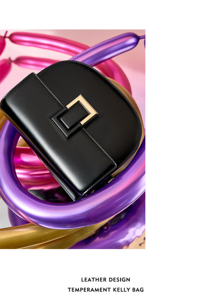 Black saddle bag styled against purple and pink balloons