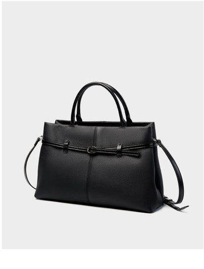 Black pebbled cowhide leather tote with shoulder strap on white background