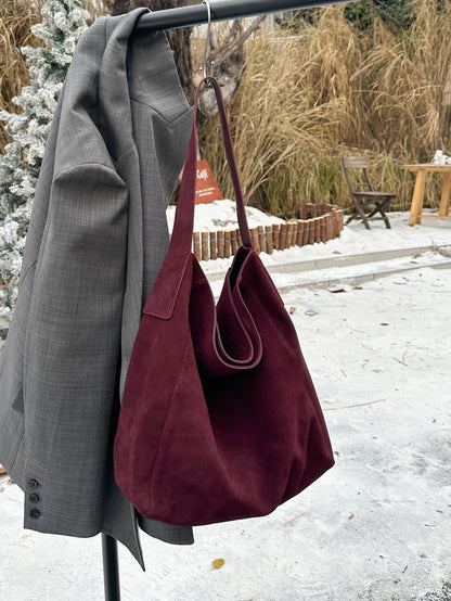 Caramel tote with a single shoulder strap and stitched seams