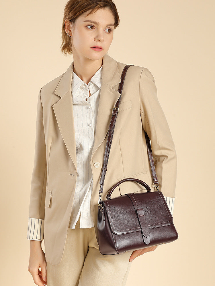 Model wearing the leather Boston bag crossbody with a narrow adjustable strap