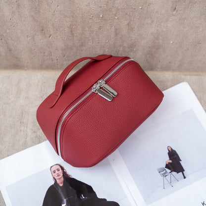 Burgundy cowhide cosmetic pouch shown from an angled view